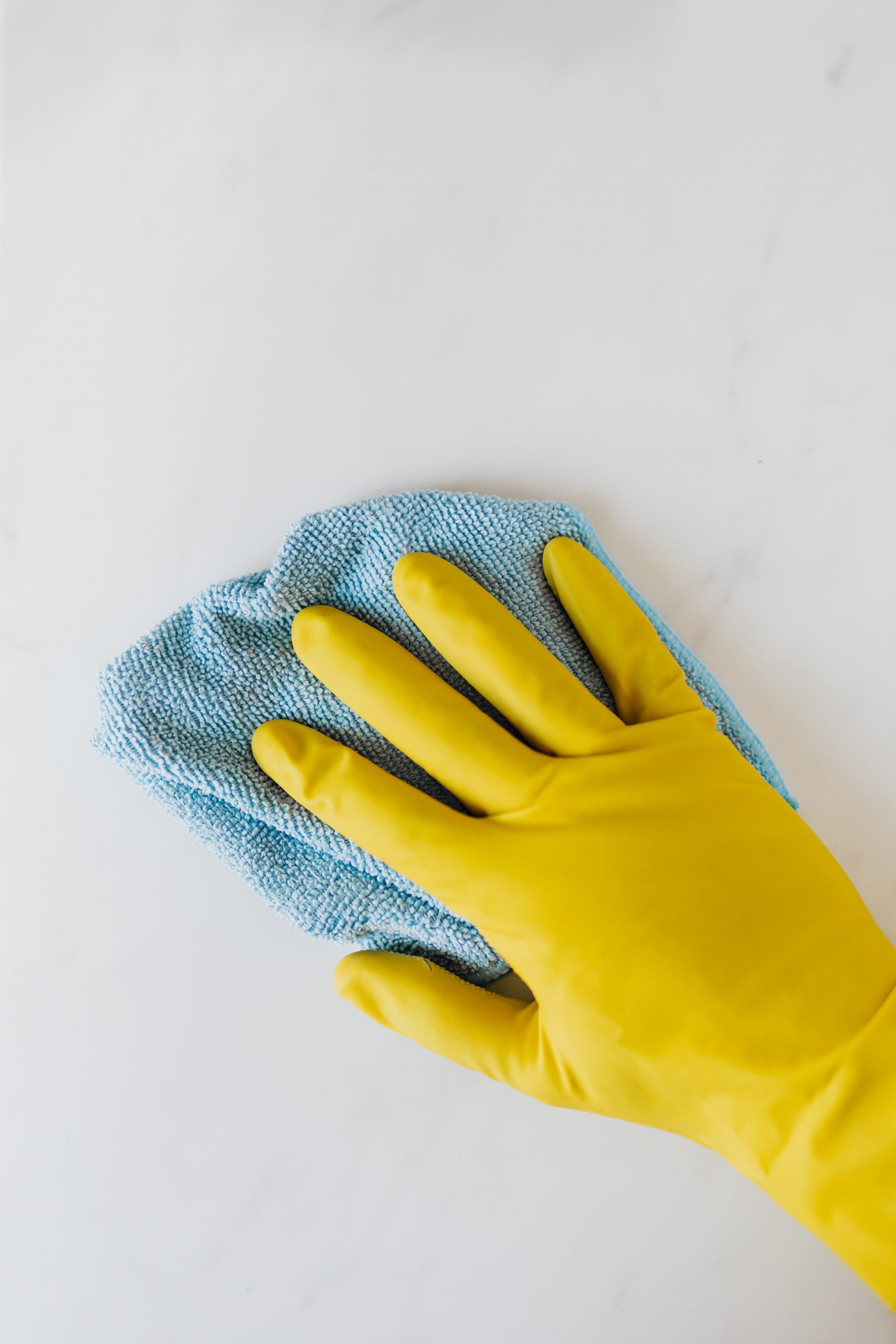 hand with cleaning glove on and a towel in the hand